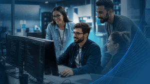 Software development team collaborating at a workstation while onboarding an external IT specialist into the project.